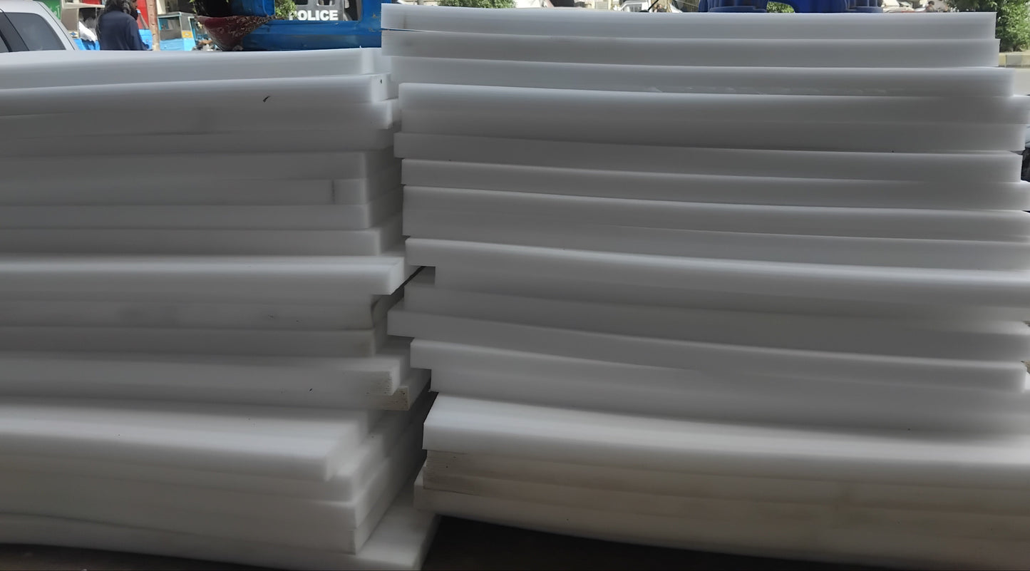 Stack of white plastic sheets with a cityscape in the background