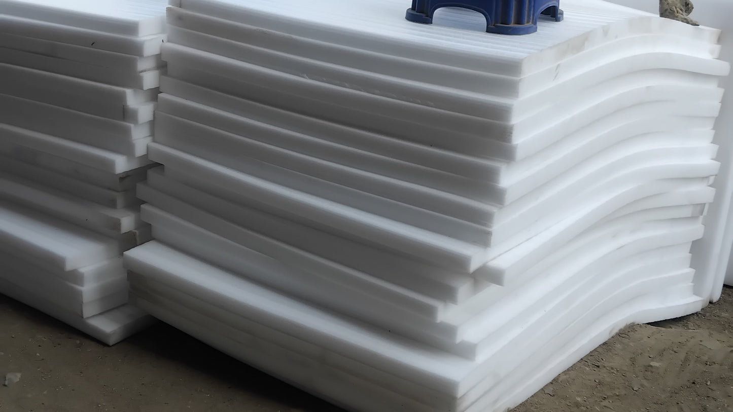 Stack of white foam boards with blue stands on a concrete surface