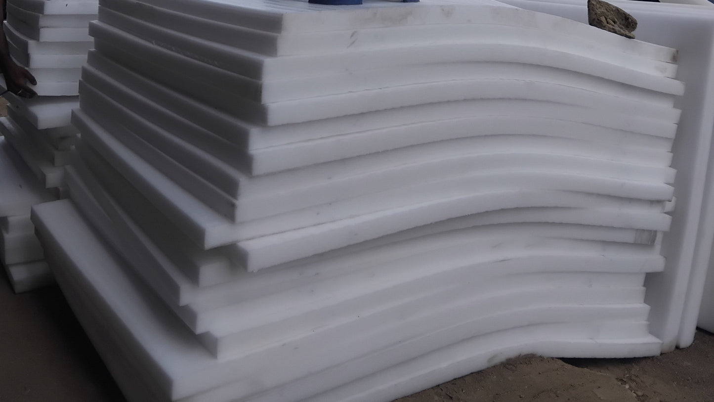 Stack of white foam sheets with a cityscape in the background